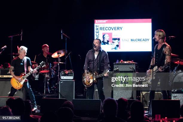 Guitarist Mike McCready , drummer Chad Smith, guitarist and singer Mike Ness and bassist Duff McKagan perform live on stage during the MusiCares...