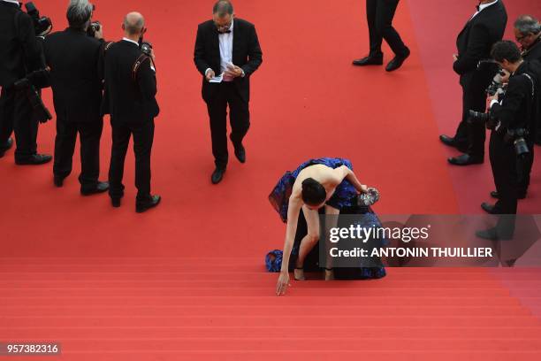 Guest stumbles on the steps as she arrives on May 8, 2018 for the screening of the film "Todos Lo Saben " and the opening ceremony of the 71st...