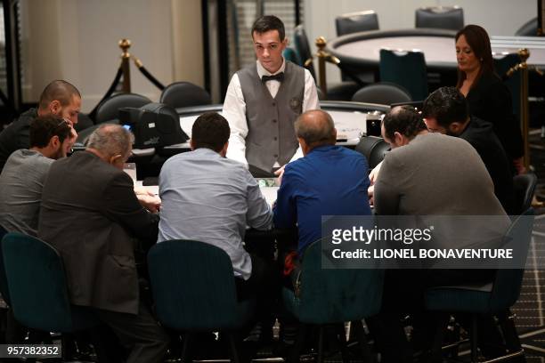 People play poker at the "Paris Elysees Club", the first "gaming club" to open its doors in the French capital in Paris, on May 9, 2018. - Casinos...