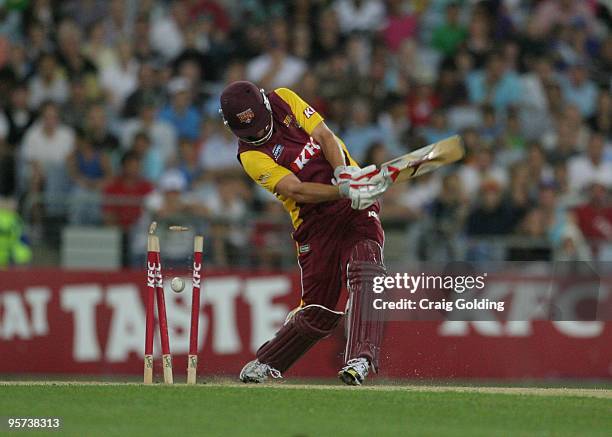 Chris Simpson of the Bulls is bowled by Mitchell Starc during the Twenty20 Big Bash match between the New South Wales Blues and the Queensland Bulls...