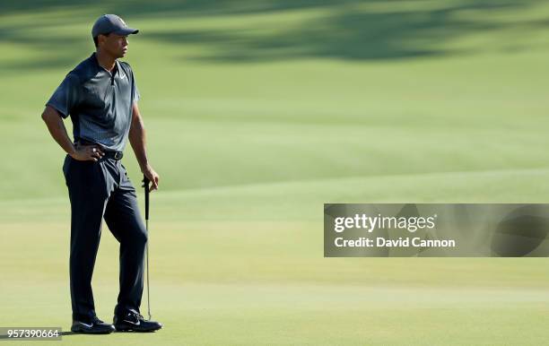 Tiger Woods of the United States waits on the green on the par 5, 11th hole during the second round of the THE PLAYERS Championship on the Stadium...