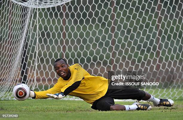 Black Stars of Ghana's goalkeeper Phelimon Maccarthy dives as he takes part to a training session on january 12, 2010 at the Chiazi stadium in...