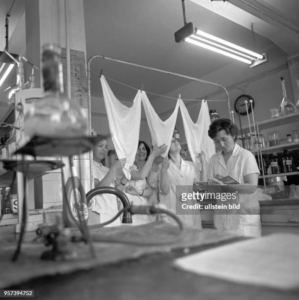 Arbeiterinnen überprüfen und begutachten Wäschstücke in einme Labor im VEB Chemiekombinat Bitterfeld, nachdem diese mit dem hier produzierten...