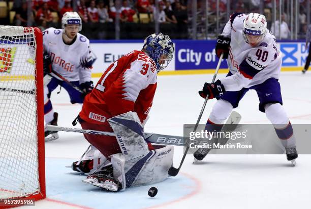 Frederik Andresen, goaltender of Denmark tends net against Ken Andre Olimb of Norway during the 2018 IIHF Ice Hockey World Championship Group B game...