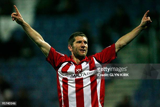 Sheffield United's English striker Richard Cresswell celebrates scoring the third goal during their FA Cup third round replay football match against...