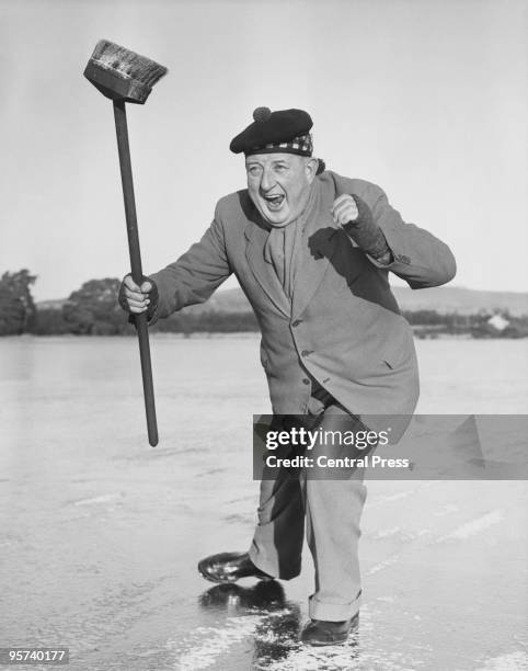 Bob Halley takes part in a curling match during a bonspiel at Stormont Loch, Perthshire, Scotland, 10th January 1959.