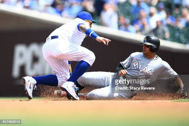 Martin Prado of the Miami Marlins is tagged out at second base by Javier Baez of the Chicago Cubs during the first inning of a game at Wrigley Field...