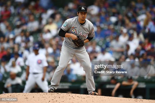 Junichi Tazawa of the Miami Marlins throws a pitch during the fourth inning of a game against the Chicago Cubs at Wrigley Field on May 9, 2018 in...