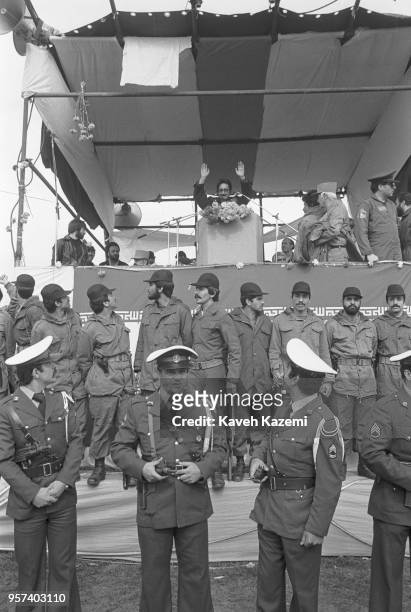 Abolhassan Bani Sadr the first Iranian president after the Iranian Revolution surrounded by army commanders and air force cadets, waves to the crowd...