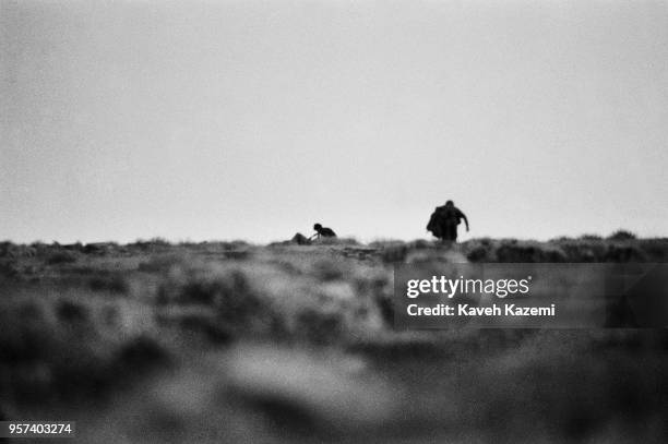 Iranian Revolutionary Guards seen during an operation to salvage the body of a martyred comrade on Kooreh-Moosh height during heavy shelling by Iraqi...