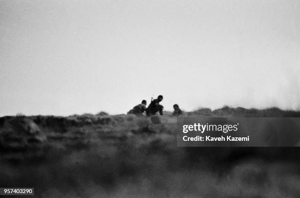 Iranian Revolutionary Guards seen during an operation to salvage the body of a martyred comrade on Kooreh-Moosh height during heavy shelling by Iraqi...