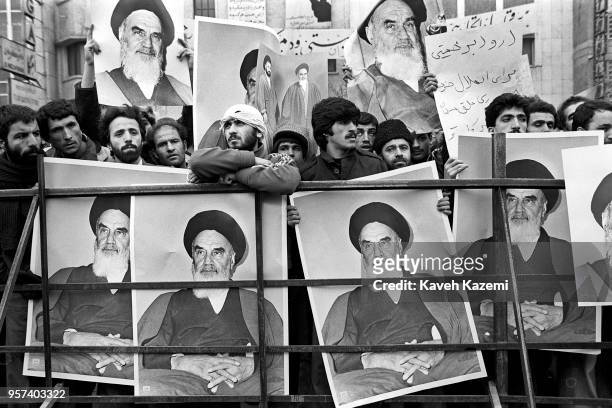 Demonstrators hold posters of Ayatollah Khomeini outside the American Embassy which is occupied by 'students following the Imam Khomeini's line' on...