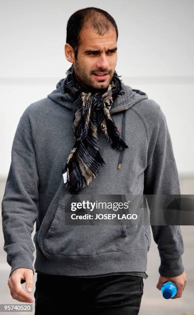 Barcelona's coach Pep Guardiola walks to give a press conference after a training session at Ciutat Esportiva Joan Gamper near Barcelona on January...
