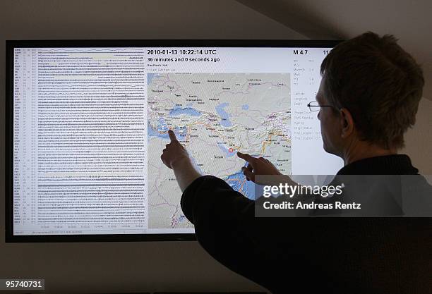 Mathias Hoffmann of the German Research Centre for Geosciences - Helmholtz Centre Potsdam shows on screen, an earthquake alert in the region of Iran,...