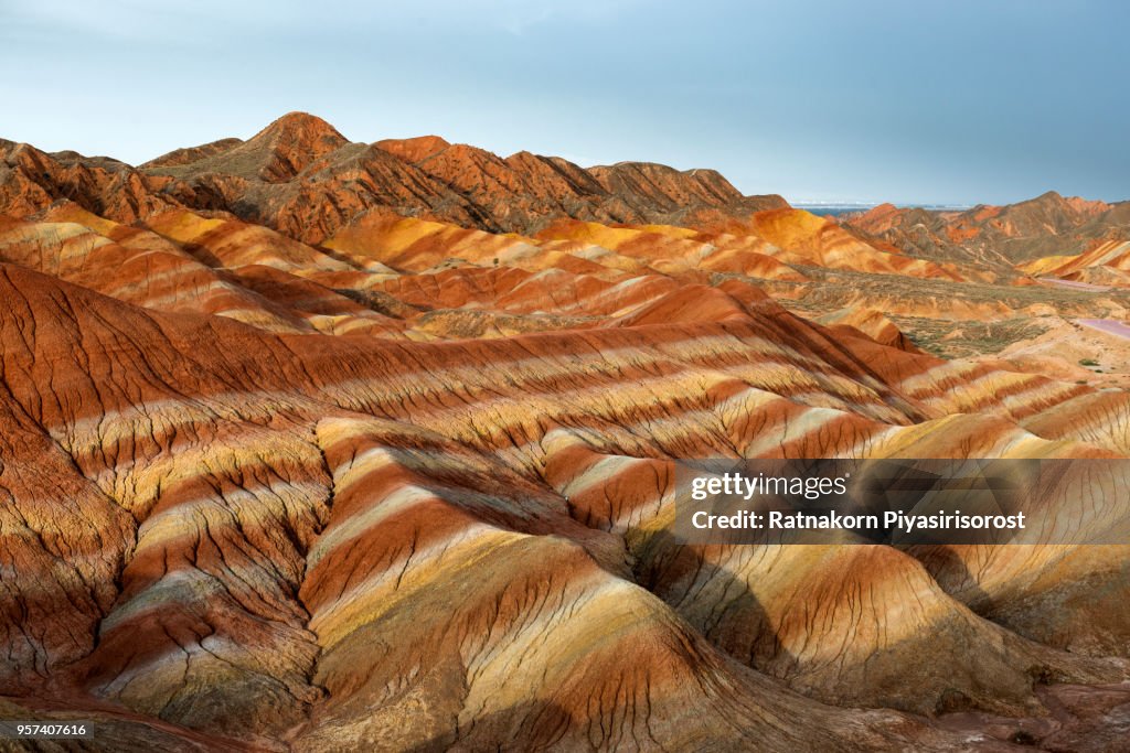 Zhangye Danxia National Geopark, Gansu, China. Colorful landscape of rainbow mountains. Walking paths around sandstone rock formation at Zhangye National Geological Park.