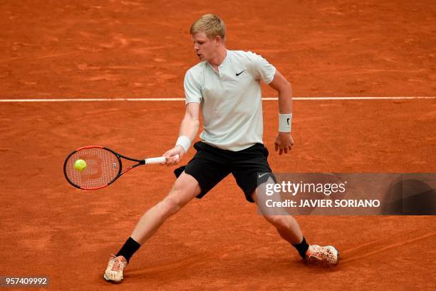 Britain's Kyle Edmund returns the ball to Canada's Denis Shapovalov during their ATP Madrid Open quarter-final tennis match at the Caja Magica in...