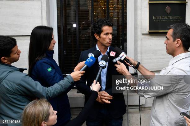 Brazil's team doctor Rodrigo Lasmar answers journalists' questions after Brazilian defender Dani Alves was ruled out of the World Cup, on May 11,...