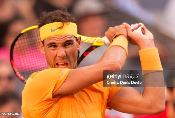 Rafael Nadal of Spain plays a backhand to Dominic Thiem of Austria during their quarterfinal match on day seven of Mutua Madrid Open at the Caja...