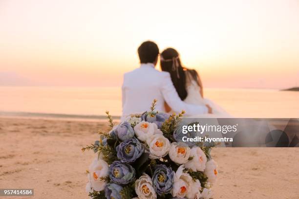 bouquet at the beach - pink wedding dress stock pictures, royalty-free photos & images