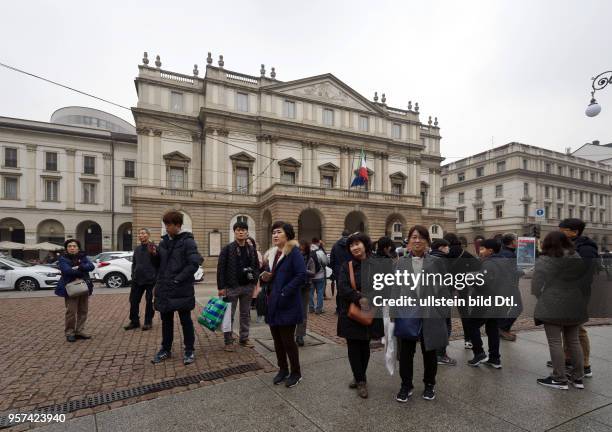 Chinese tourists in front of the opera house Scala in Milan ,