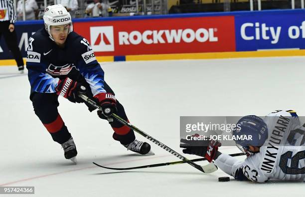 Johnny Gaudreau of the United States challenges for the puck with South Korea's Park Jin-kyu during the group B match the United States vs South...