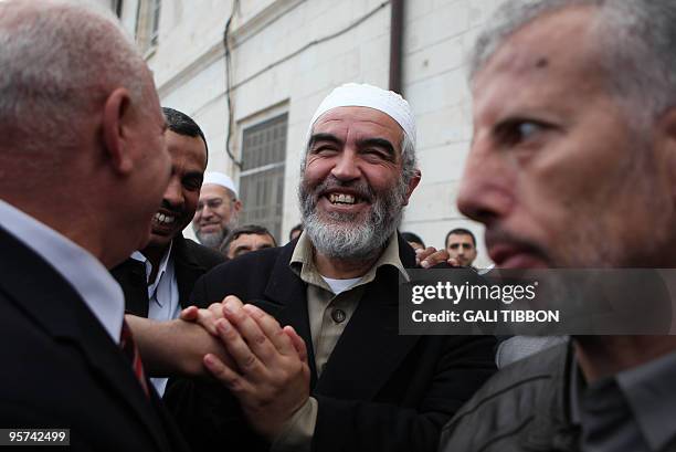 Head of the Islamic northern Movement of Israel, Sheikh Raed Salah, greets people after receiving his court sentence in Jerusalem on January 13,...