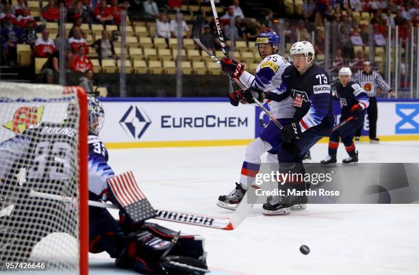 Charlie McAvoy of United States and Brock Radunske of Korea battle for the puck during the 2018 IIHF Ice Hockey World Championship group stage game...