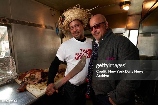 Lechonera La Pirana food stand's Angel Jiminez, left, with Andrew Zimmern of Travel Channel's "Bizarre Foods", on Thursday, April 14, 2016 in the...