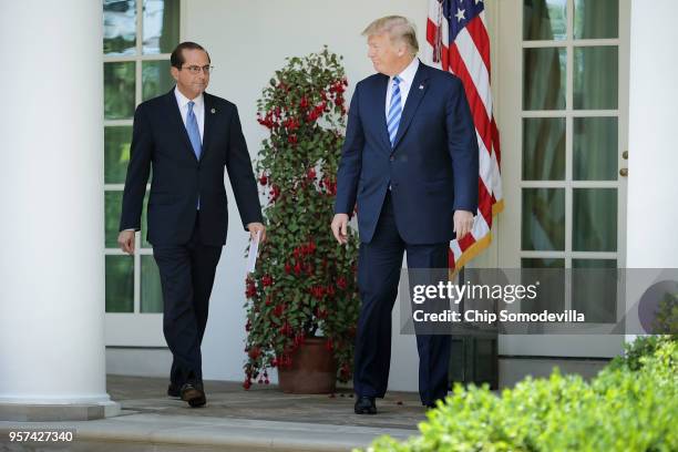 Health and Human Services Secretary Alex Azar and President Donald Trump walks into the Rose Garden before making an announcement about drug prices...