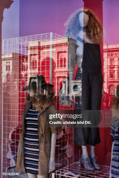 The shopping mall Galleria Vittorio Emanuele II in Milan is reflecting in a window pane ,