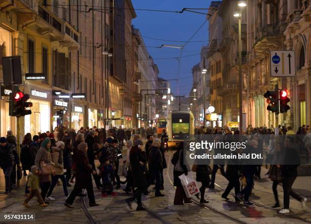 Pedestrians in Milan at nighttime ,