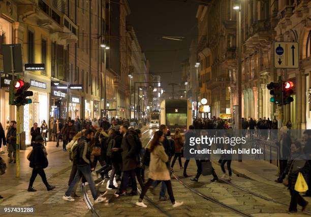 Pedestrians in Milan at nighttime ,