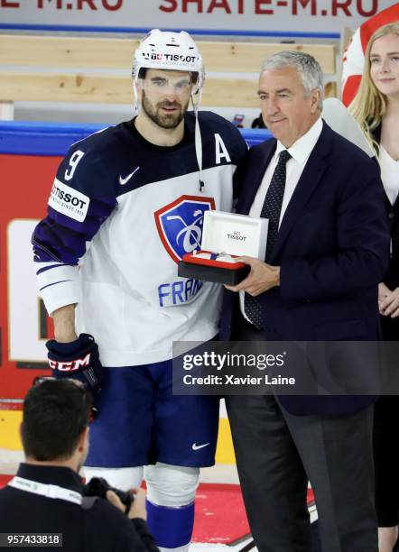 Damien Fleury of France receives the best player of the game award with Luc Tardif during the 2018 IIHF Ice Hockey World Championship Group A between...