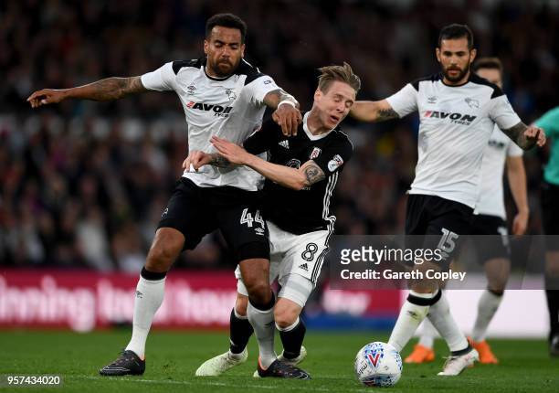 Stefan Johansen of Fulham is challenged by Tom Huddlestone of Derby County during the Sky Bet Championship Play Off Semi Final:First Leg match...
