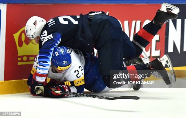 South Korea's Eric Regan and Tage Thompson of the United States fall during the group B match USA versus South Korea of the 2018 IIHF Ice Hockey...