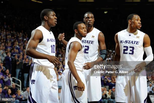 Players Victor Ojeleye, Jacob Pullen, Jamar Samuels and Dominique Sutton of the Kansas State Wildcats look to the bench during a game against the...
