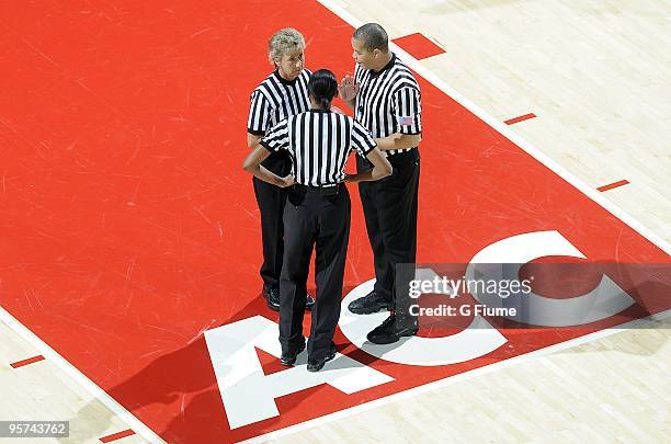 Officials Joanne Aldrich, Daryl Humphrey and Geraldine Smith talk during the game between the Maryland Terrapins and the Loyola Greyhounds at the...
