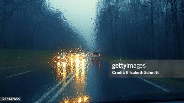 view through car's front window on a rainy day - crash barrier stock pictures, royalty-free photos & images