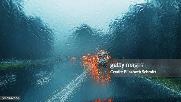 view through car's front window on a rainy day - crash barrier stock pictures, royalty-free photos & images