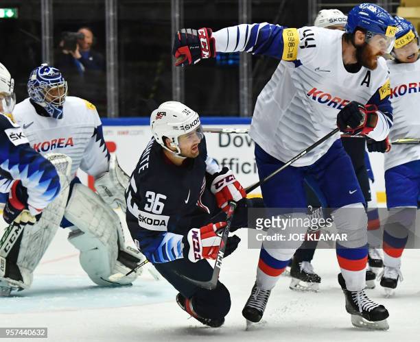 Colin White of the United States falls behind South Korea's Alex Plante during the group B match the United States vs South Korea of the 2018 IIHF...