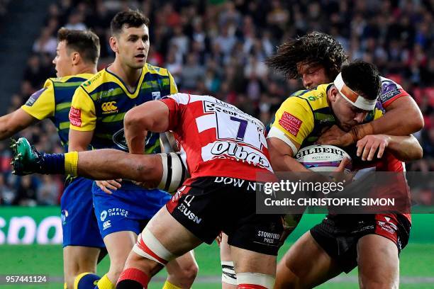 Cardiff Blues' Welsh flanker and captain Ellis Jenkins is tackled by Gloucester's New Zealander prop Josh Hohneck and Gloucester's English flanker...