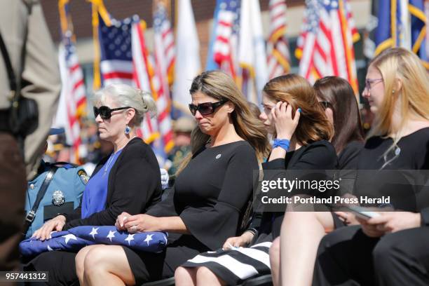 Family members react after being presented flags during the funeral service for Cpl. Eugene Cole in Bangor on Monday, May 7, 2018.