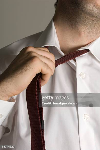 businessman loosening necktie, close-up - loose tie stock pictures, royalty-free photos & images
