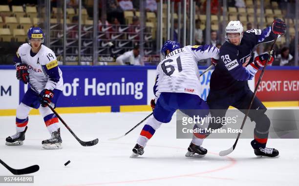 Tage Thompson of United States and Don Ku Lee of Korea battle for the puck during the 2018 IIHF Ice Hockey World Championship group stage game...