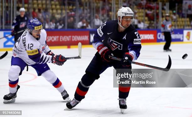 Dylan Larkin of United States and Hyeongcheol Song of Korea battle for the puck during the 2018 IIHF Ice Hockey World Championship group stage game...