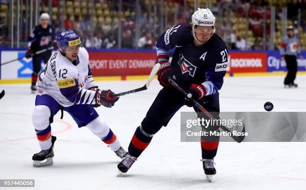 Dylan Larkin of United States and Hyeongcheol Song of Korea battle for the puck during the 2018 IIHF Ice Hockey World Championship group stage game...