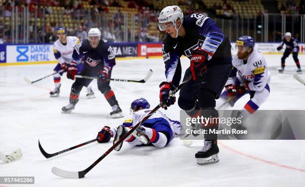 Tage Thompson of United States and Hyonho Oh of Korea battle for the puck during the 2018 IIHF Ice Hockey World Championship group stage game between...