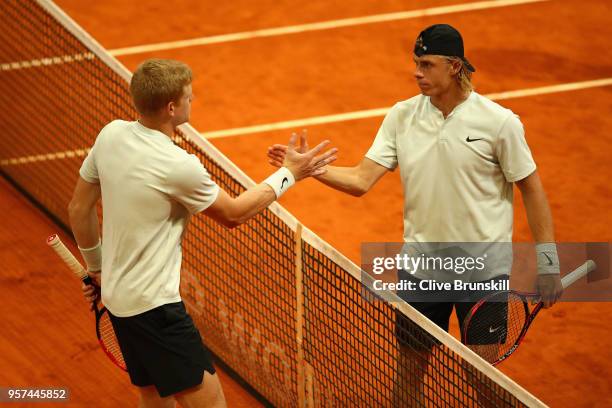 Kyle Edmund of Great Britain and Denis Shapvalov of Canada shake hands after their singles match during day seven of Mutua Madrid Open at La Caja...
