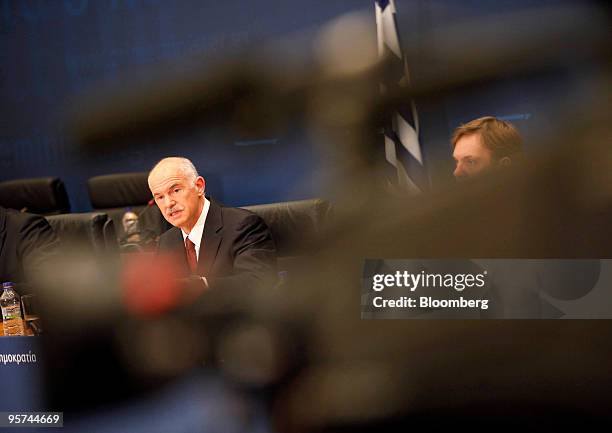 George Papandreou, Greece's prime minister, left, speaks at a press conference in Athens, Greece, on Wednesday, Jan. 13, 2010. Greece will not leave...