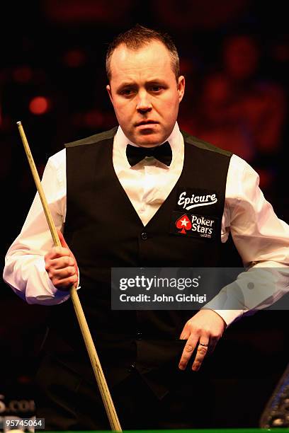 John Higgins of Scotland contemplates a shot in his match against Mark Allen of Ireland during the PokerStars Masters snooker tournament at Wembley...